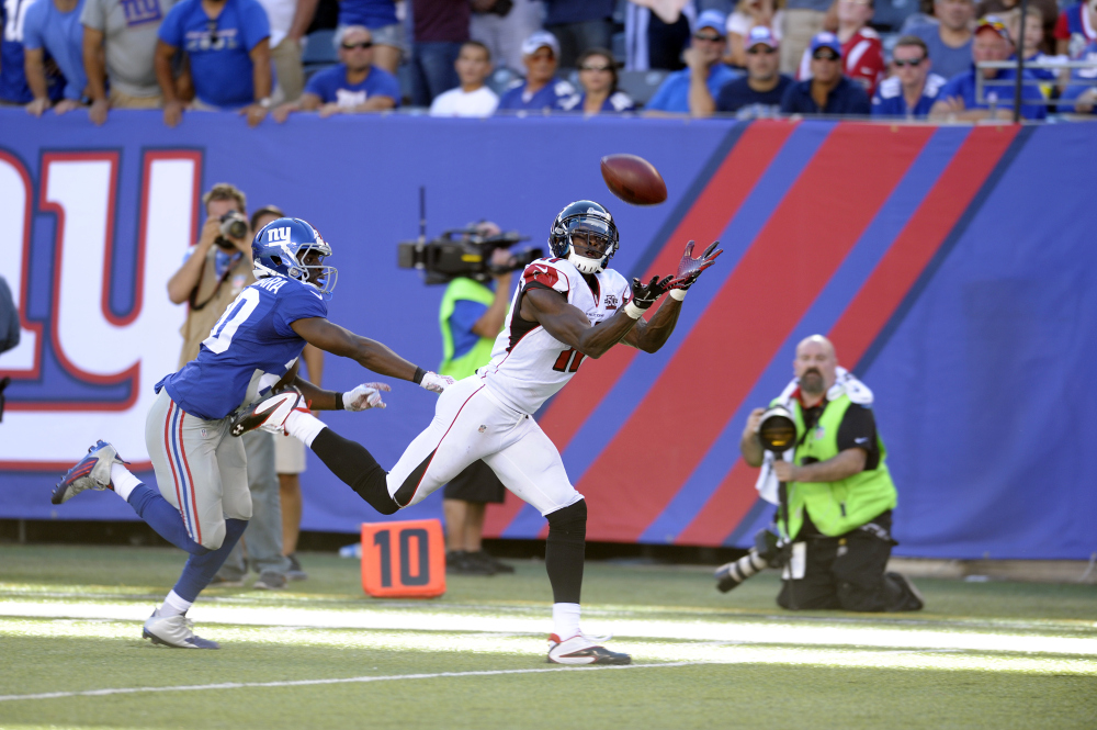 Atlanta Falcons wide receiver Julio Jones, right, makes a catch near the end zone on a pass from quarterback Matt Ryan, not pictured, as New York Giants cornerback Prince Amukamara defends on the play during the second half of an NFL football game, Sunday, Sept. 20, 2015, in East Rutherford, N.J.
