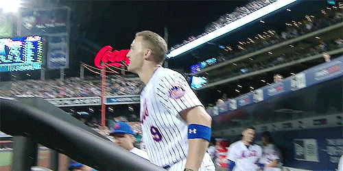 New York Mets outfielder Brandon Nimmo takes a curtain call from the fans after a home run.